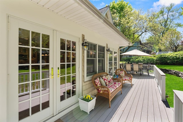 wooden terrace featuring outdoor dining area and french doors