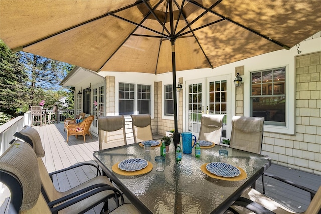wooden deck featuring french doors and outdoor dining space