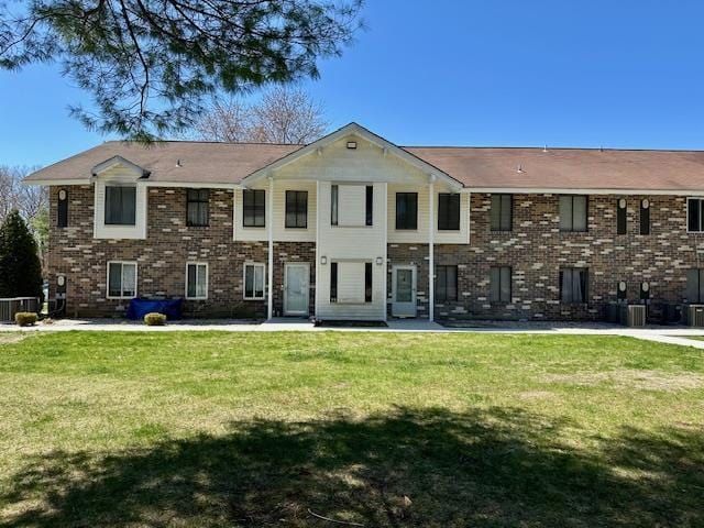 3 Kiowa Ct Unit 3K, Coram, NY 11727 - back of house with brick siding, a yard, and cooling unit