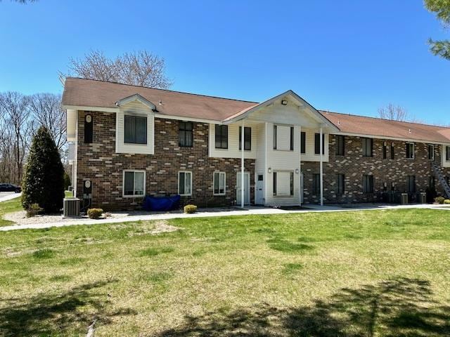 3 Kiowa Ct Unit 3K, Coram, NY 11727 - view of front of property featuring central AC, brick siding, and a front yard