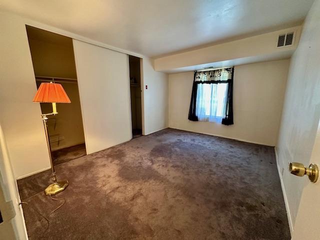 3 Kiowa Ct Unit 3K, Coram, NY 11727 - unfurnished bedroom with visible vents, carpet floors, and a closet