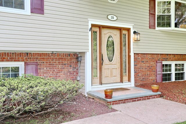 view of exterior entry with brick siding