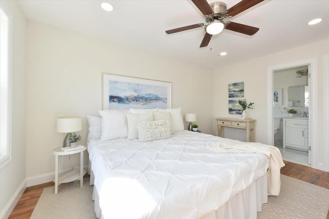 bedroom featuring light wood finished floors, recessed lighting, and baseboards