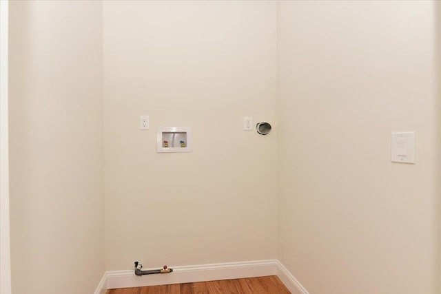 laundry room featuring baseboards, hookup for a washing machine, light wood-type flooring, and laundry area
