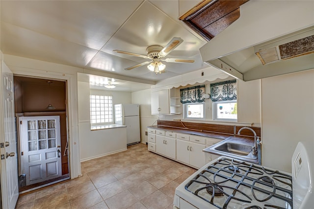 kitchen featuring white cabinets, range hood, open shelves, a sink, and white appliances