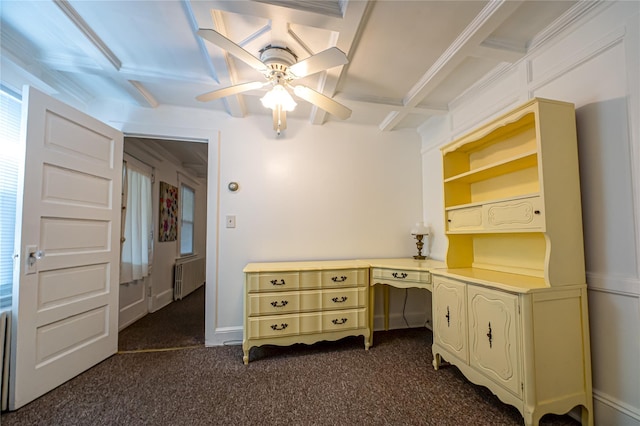 unfurnished office with radiator, coffered ceiling, dark colored carpet, and ceiling fan