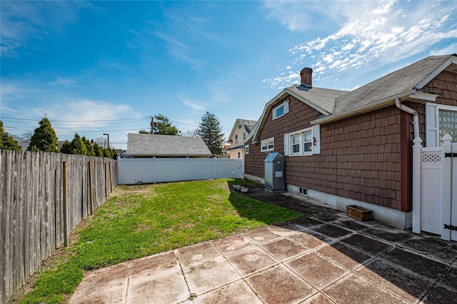 view of yard with a patio area and a fenced backyard