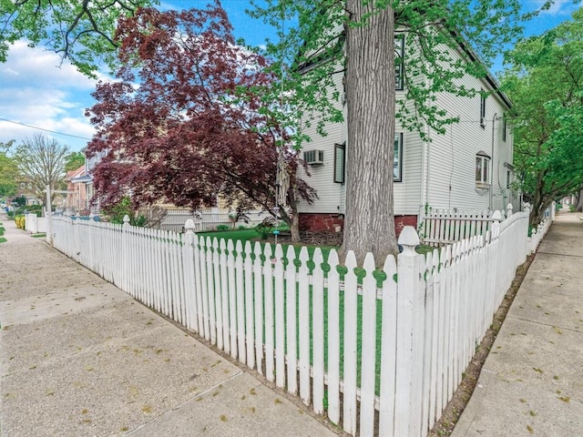 123-19 7th Ave, College Point, NY 11356 - view of side of property with a fenced front yard and a wall mounted AC