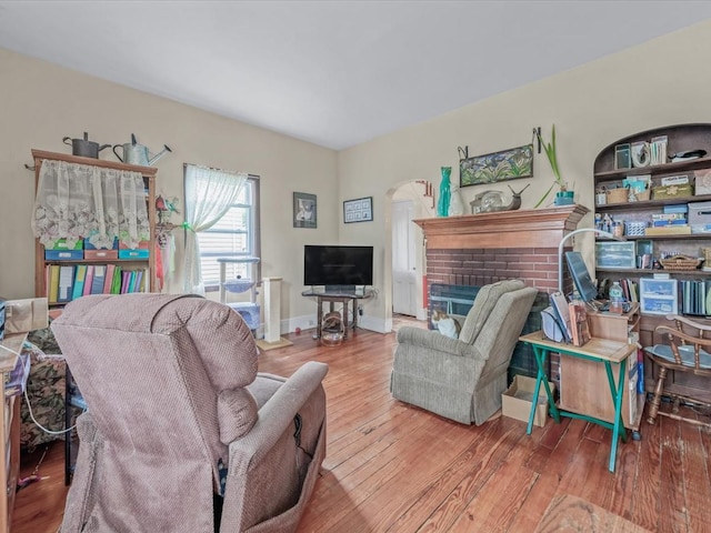 123-19 7th Ave, College Point, NY 11356 - living room featuring baseboards, a brick fireplace, and wood finished floors