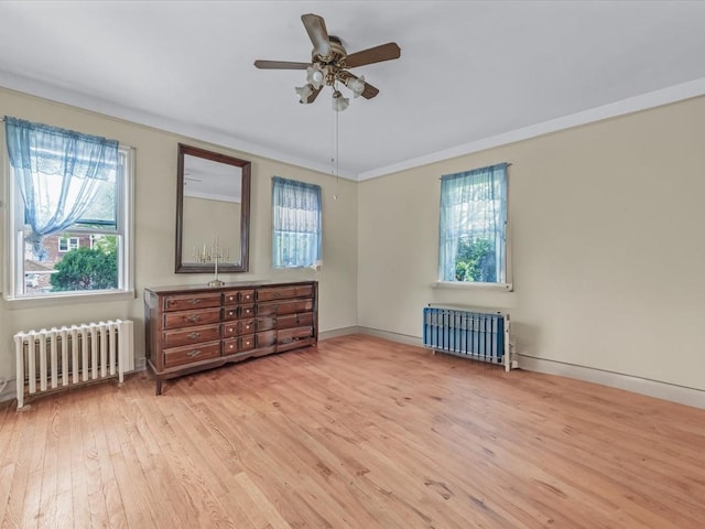 123-19 7th Ave, College Point, NY 11356 - empty room featuring wood finished floors, baseboards, ceiling fan, and radiator heating unit