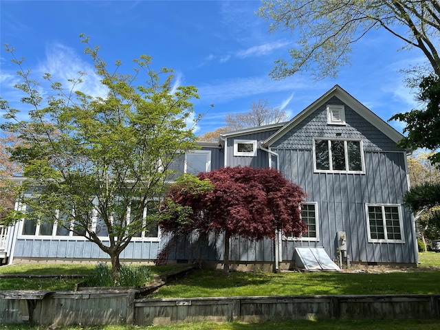 back of house with a yard and board and batten siding