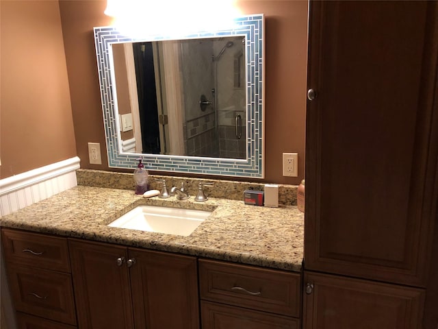 bathroom featuring a stall shower and vanity