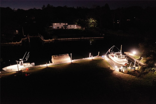 yard at night featuring a dock