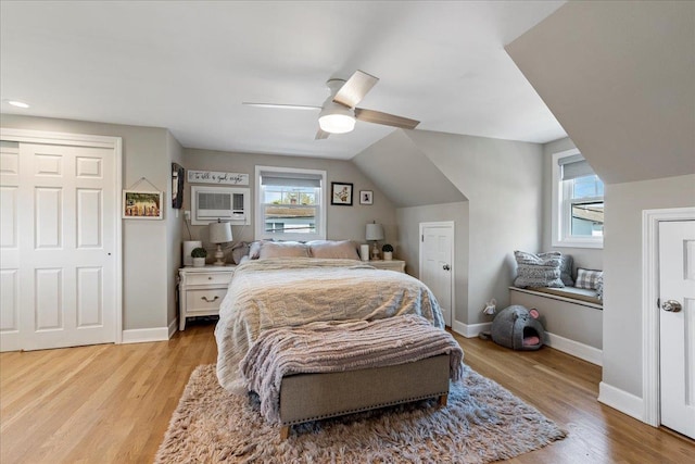 bedroom featuring baseboards, multiple windows, and light wood-style flooring
