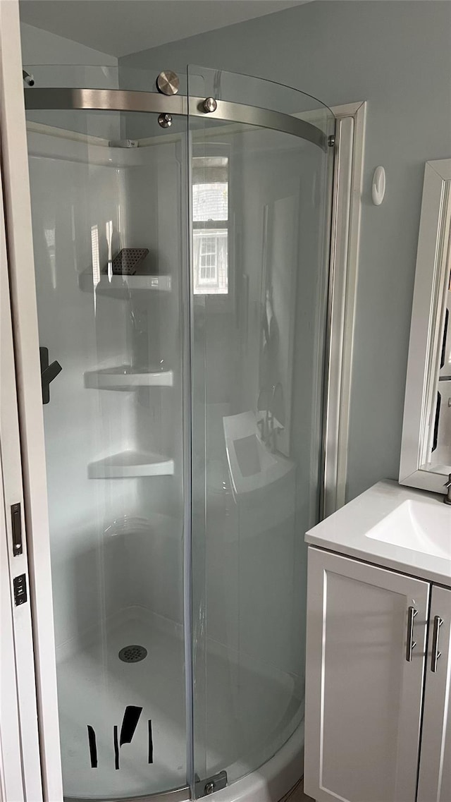 bathroom featuring a shower stall and vanity