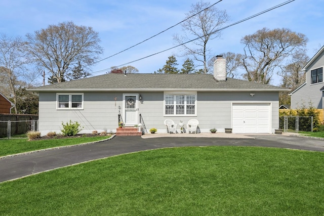 ranch-style house with fence, aphalt driveway, and a front yard