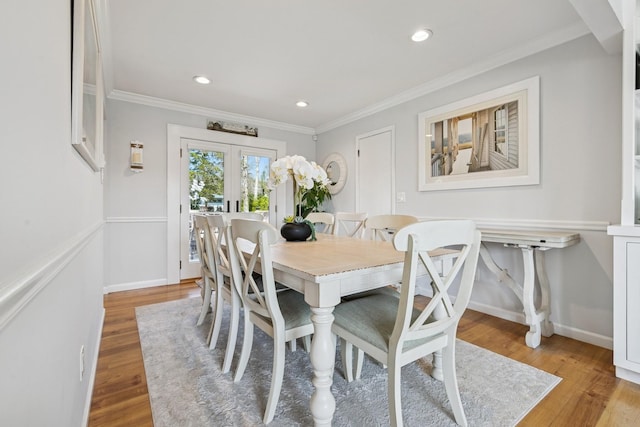dining area with ornamental molding, french doors, recessed lighting, and light wood finished floors