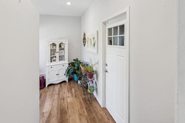 corridor with recessed lighting and light wood-style flooring