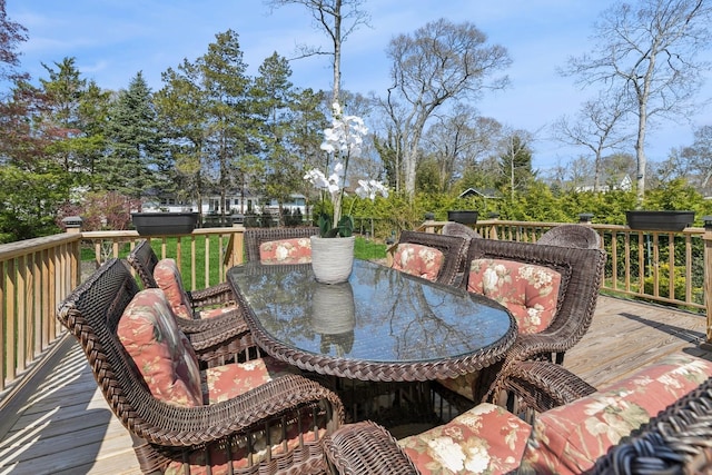 wooden deck featuring outdoor dining area