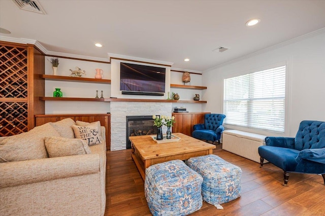 living area featuring ornamental molding, dark wood-style floors, and visible vents