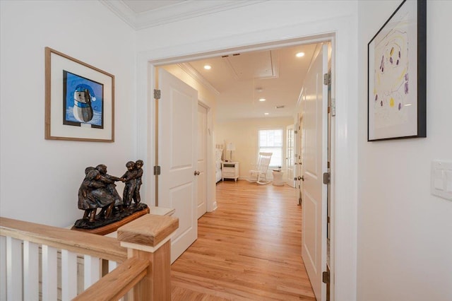 corridor featuring crown molding, baseboards, attic access, light wood-type flooring, and recessed lighting