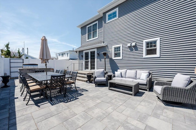 view of patio featuring a fenced backyard, an outdoor hangout area, and outdoor dining area