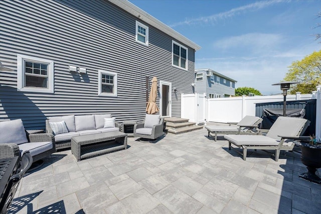 view of patio with outdoor lounge area and fence