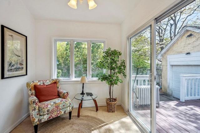 sunroom / solarium featuring baseboards and tile patterned floors