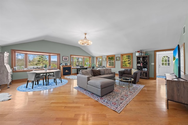 21 Rhinecliff Rd, Brewster, NY 10509 - living area featuring visible vents, vaulted ceiling, light wood-type flooring, and a notable chandelier