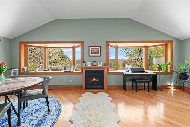 21 Rhinecliff Rd, Brewster, NY 10509 - home office with baseboards, vaulted ceiling, a warm lit fireplace, and wood finished floors