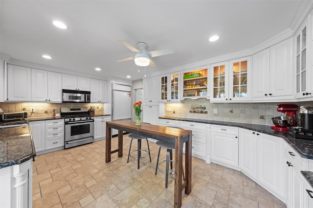 21 Rhinecliff Rd, Brewster, NY 10509 - kitchen featuring appliances with stainless steel finishes, backsplash, white cabinets, and ceiling fan