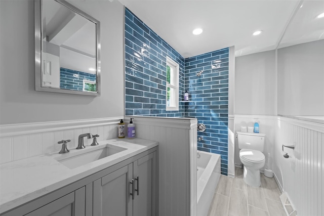 21 Rhinecliff Rd, Brewster, NY 10509 - bathroom featuring tile walls, wainscoting, shower / tub combination, vanity, and toilet