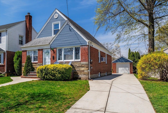 view of front of property featuring an outdoor structure, brick siding, a front yard, and a detached garage