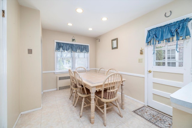 dining space with radiator heating unit, baseboards, recessed lighting, and light tile patterned flooring