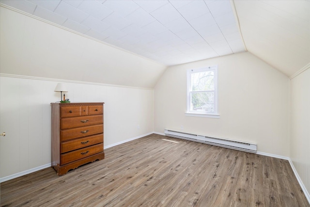 bonus room featuring wood finished floors, lofted ceiling, and baseboard heating