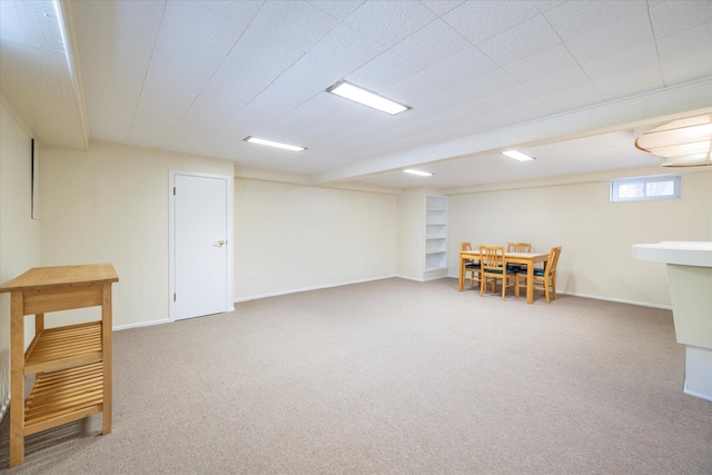 basement with baseboards and carpet flooring