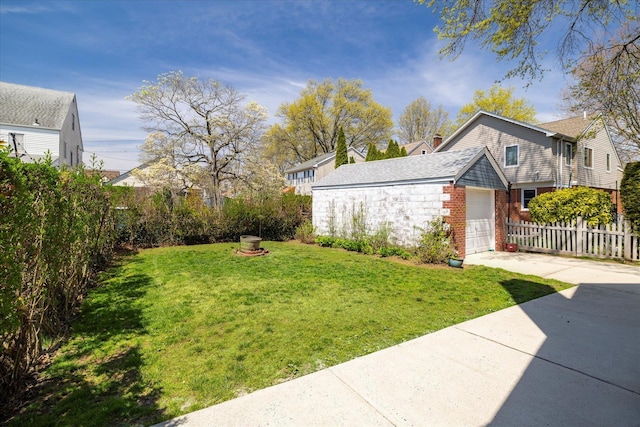 exterior space with fence, an attached garage, and driveway