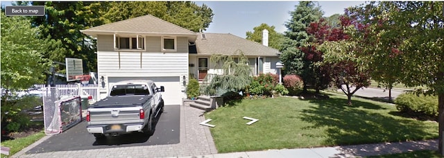tri-level home featuring a front lawn, a garage, and aphalt driveway