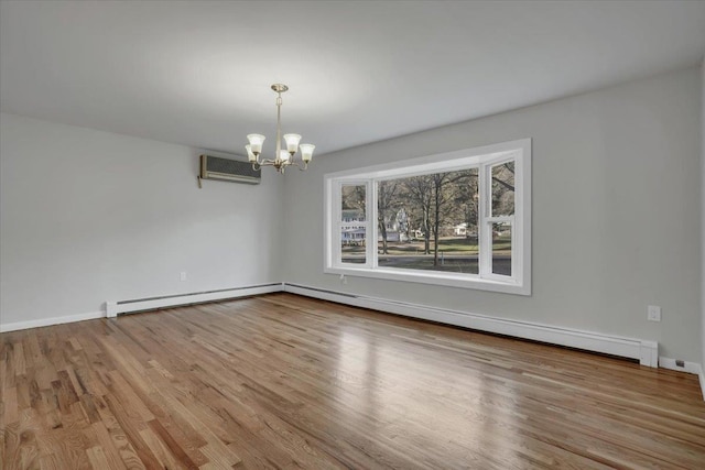 unfurnished room featuring a notable chandelier, a wall unit AC, wood finished floors, and a baseboard radiator