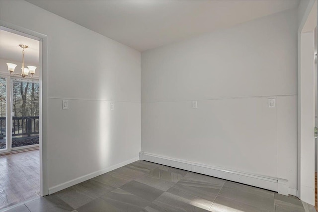 spare room featuring an inviting chandelier and a baseboard radiator