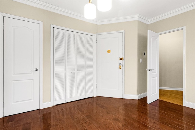 unfurnished bedroom featuring baseboards, ornamental molding, and wood finished floors