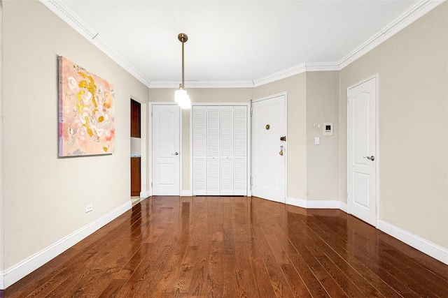 unfurnished bedroom featuring baseboards, crown molding, and wood finished floors