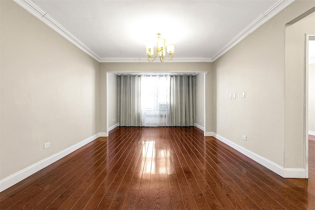 unfurnished room featuring a chandelier, hardwood / wood-style flooring, crown molding, and baseboards