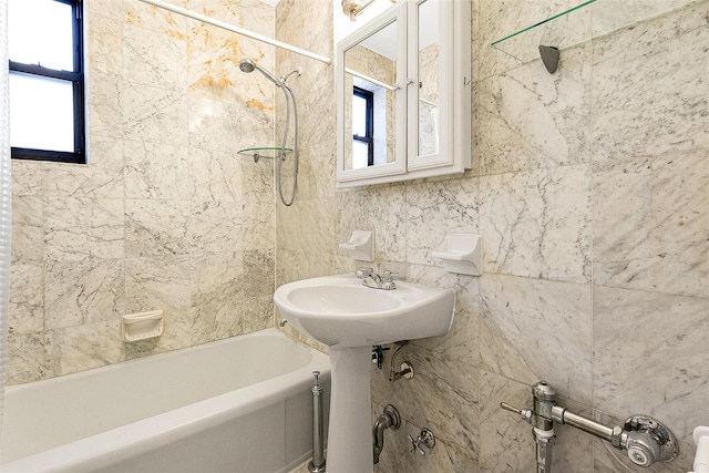 full bath featuring a wealth of natural light and bathing tub / shower combination