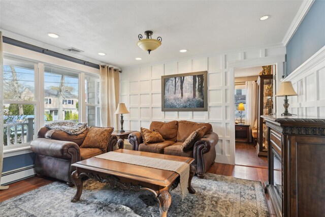 living area featuring recessed lighting, dark wood-type flooring, crown molding, visible vents, and baseboard heating