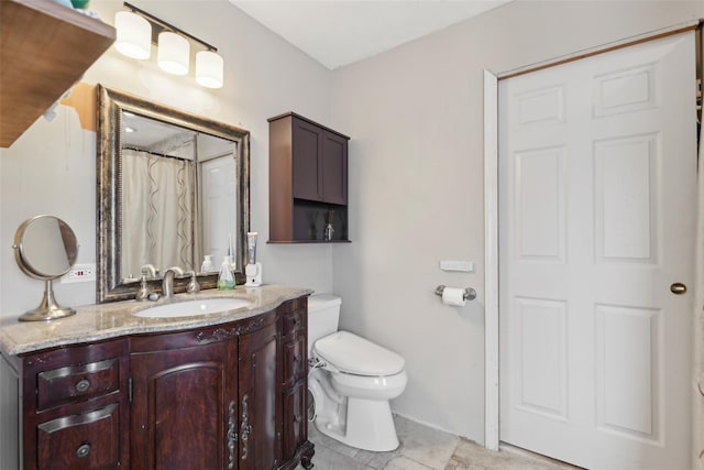 bathroom featuring vanity, toilet, and tile patterned flooring