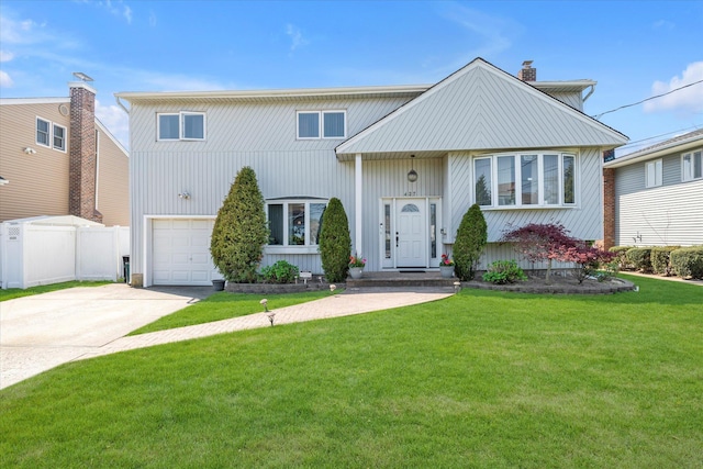 427 Wanamaker St, Oceanside, NY 11572 - view of front of property featuring a chimney, fence, a garage, driveway, and a front lawn