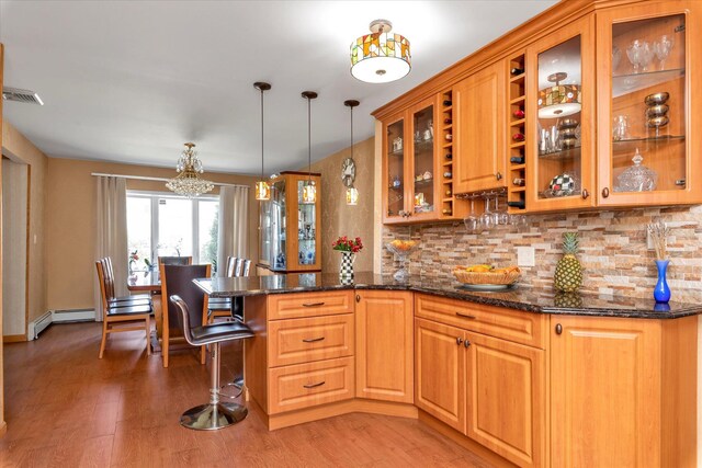 427 Wanamaker St, Oceanside, NY 11572 - kitchen featuring tasteful backsplash, visible vents, light wood-type flooring, a peninsula, and a notable chandelier
