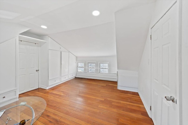 additional living space with vaulted ceiling, recessed lighting, and light wood-style floors