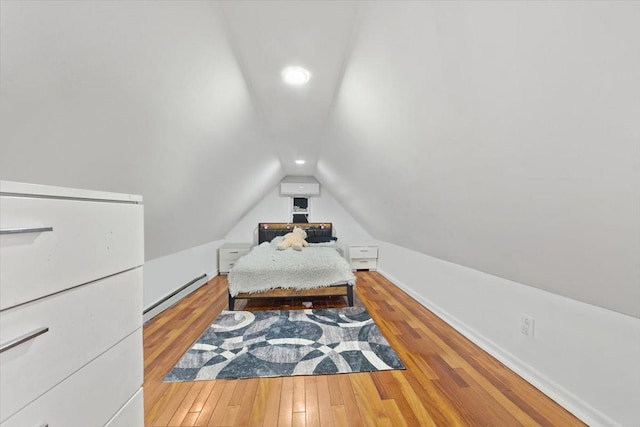 bedroom featuring baseboard heating, wood finished floors, baseboards, lofted ceiling, and recessed lighting